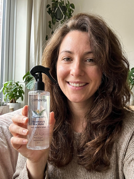 Customer holding SomaVita Vita Nourish Spray